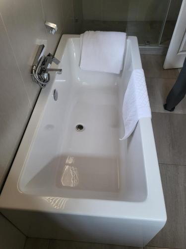 a white sink in a bathroom with a towel on it at Ultimate Sky in Pretoria
