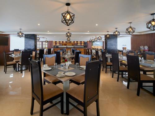a dining room with a table and chairs at Essentia Premier Hotel Chennai OMR in Chennai