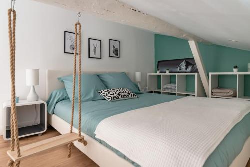 a bedroom with a bed with a swing at L'Impérial - St Genis Centre in Saint-Genis-Laval