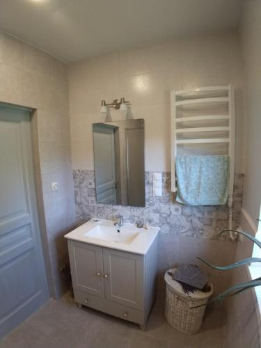 a bathroom with a white sink and a mirror at AromaHouse in Lipliūnai