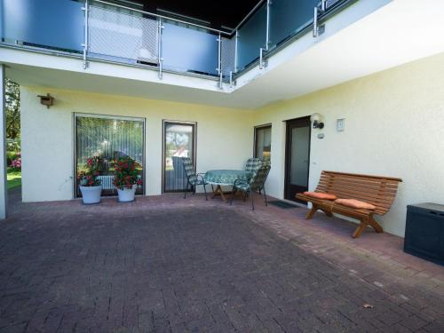 a patio with a bench and a table and chairs at Ferienwohnung Zum Deichgrafen in Bachem