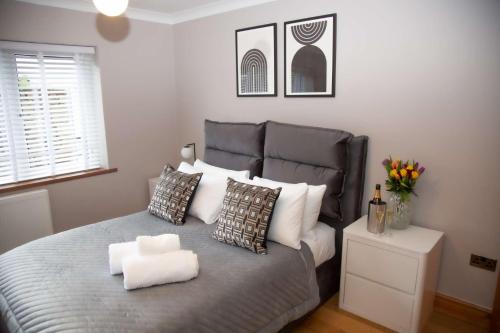 1 dormitorio con 1 cama grande con almohadas blancas en Millbrook Lodge, en Lake District National Park