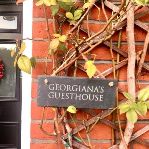 a sign on the side of a brick building at Georgiana's Guesthouse in London