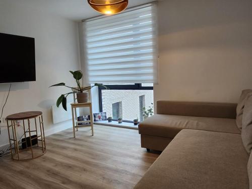 a living room with a couch and a large window at Lovely Luxury Apartment with Free Parking 801 in Luton