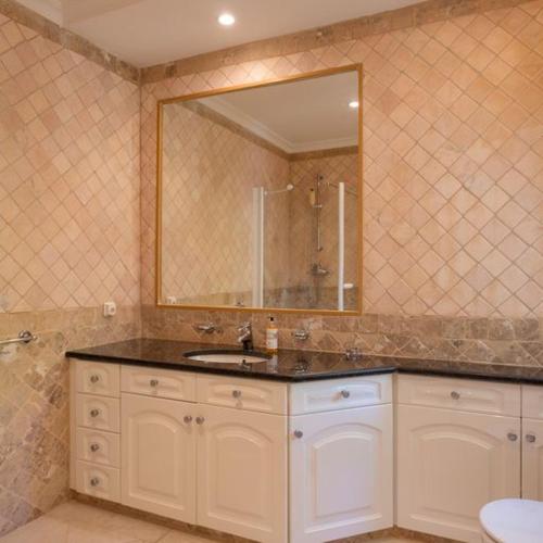 a bathroom with a sink and a mirror at Apartment Kairi in Vale do Lobo