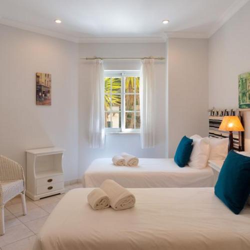 a white room with two beds and a window at Apartment Kairi in Vale do Lobo