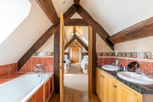 a bathroom with two sinks and a bath tub at The Town House Ludlow in Ludlow