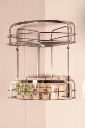 a metal shelf hanging from a wall with some containers at Ekaterinoslav in Dnipro