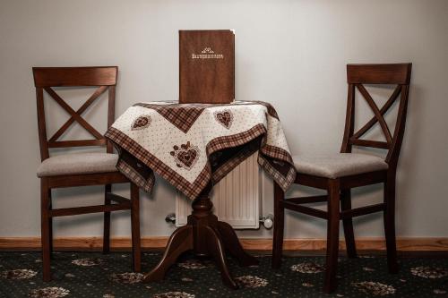 a table with a quilt on top of two chairs at Ekaterinoslav in Dnipro