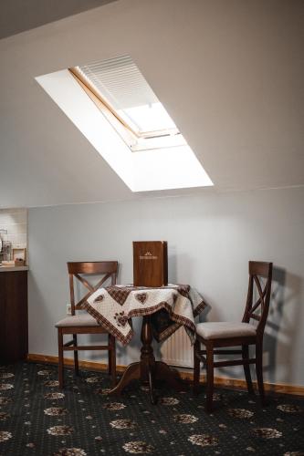 a room with two chairs and a table with a skylight at Ekaterinoslav in Dnipro