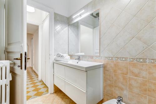 a white bathroom with a sink and a mirror at NEW!! SPAGNA Suite - Your Italian Holidays in Rome