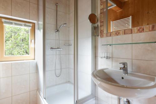 a bathroom with a sink and a shower at Ferienhaus Oetztal in Sautens