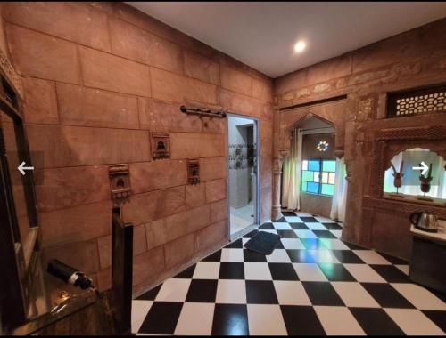 a room with a checkered floor and a door at The Kutumb Villa - A Heritage Home Stay in Jodhpur