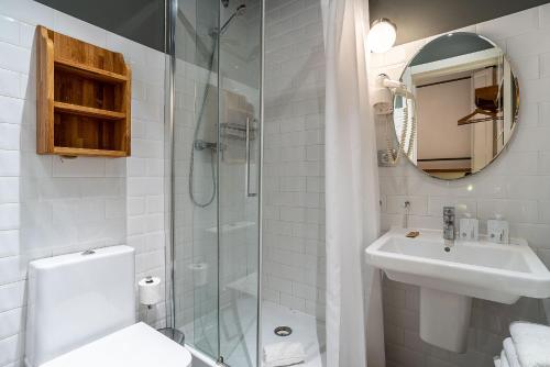 a bathroom with a shower and a sink and a toilet at Casa Gracia in Barcelona