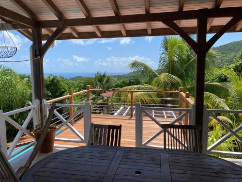 a view from the deck of a house at LE DIAMANT Charmante Villa pour la famille ou entre amis SPA et Piscine in Le Diamant
