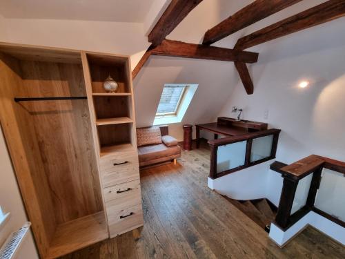an attic room with a desk and a chair at Appartment Montfort in Feldkirch