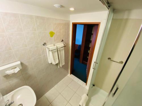 a bathroom with a shower and a toilet and a sink at Hotel Pietrak in Trzemeszno