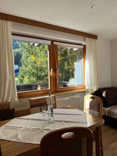 a dining room with a table and a window at Ferienwohnungen Ötztal in Sautens