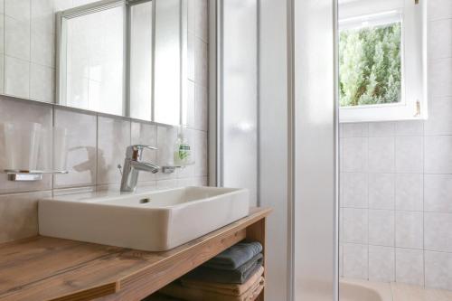 a bathroom with a sink and a mirror at Ferienwohnungen Ötztal in Sautens