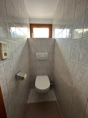 a bathroom with a toilet in a tiled room at Ferienwohnungen Ötztal in Sautens