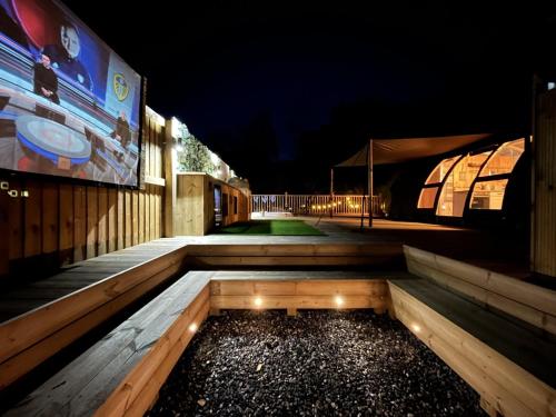 a night view of a walkway with lights on it at Moonlight Dome Tent in Tenby