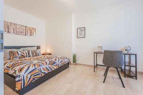 a bedroom with a bed and a desk and a chair at Carolina's Great Choice For Your Stay At Hradec Kralove in Hradec Králové