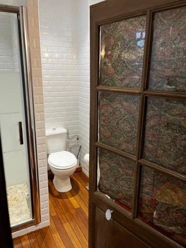 a bathroom with a toilet and a glass door at Chambres d'hôtes Place Balanant in Buzançais