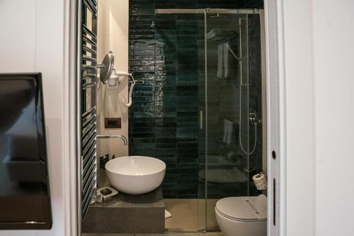 a bathroom with a sink and a glass shower at Splendid Hotel Taormina in Taormina