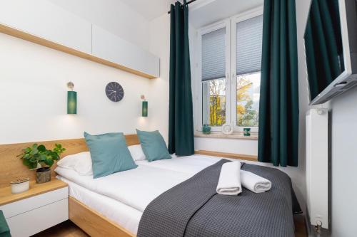 a bedroom with a bed and a window at Kraków Trendy Studio Apartments by Renters in Krakow