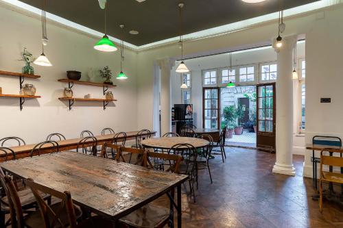 a dining room with tables and chairs and windows at Casa Gracia in Barcelona