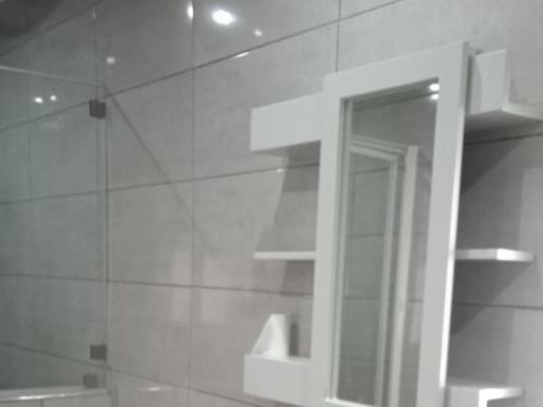 a bathroom with a mirror and a shower stall at Kaste guesthouse Tzaneen in Tzaneen