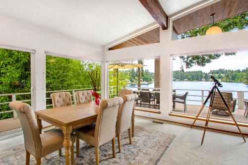 a dining room with a table and chairs and large windows at St Claires Halo in Olympia