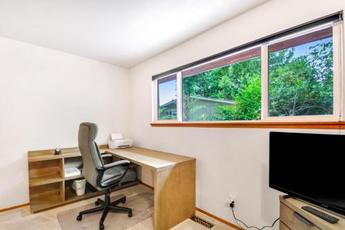 an office with a desk and a chair and a window at St Claires Halo in Olympia