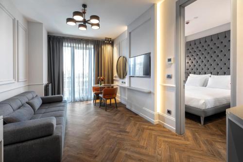 a hotel room with a bed and a couch at Wish More Hotel Şişli in Istanbul