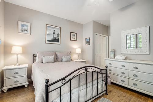 a bedroom with a bed and two night stands at Bear Trap Dunes 16 Sycamore St in Ocean View