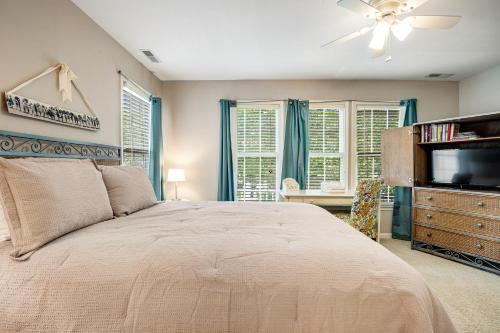 a bedroom with a bed and a flat screen tv at Bear Trap Dunes 16 Sycamore St in Ocean View