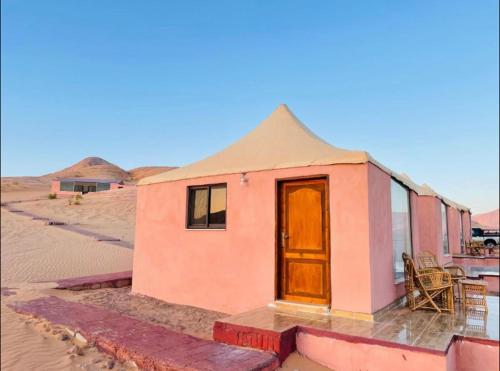 a small house in the middle of the desert at Rum Jordan camp and tours in Wadi Rum