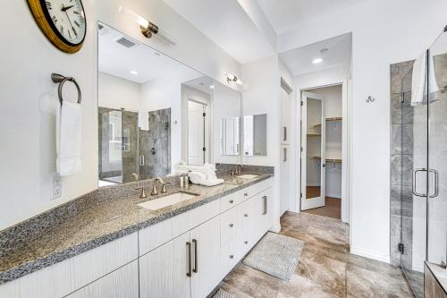 a bathroom with two sinks and a large mirror at Desert Princess Permit# BLIC-000,382-2022 in Cathedral City