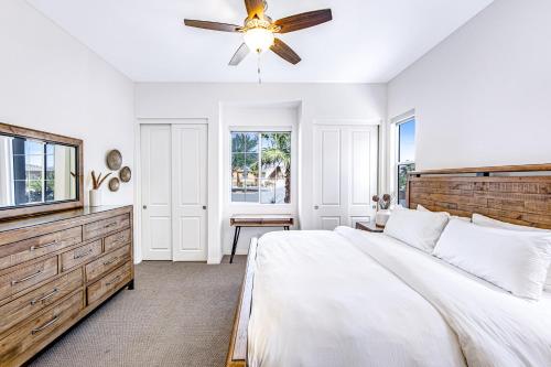 a white bedroom with a bed and a ceiling fan at Desert Princess Permit# BLIC-000,382-2022 in Cathedral City