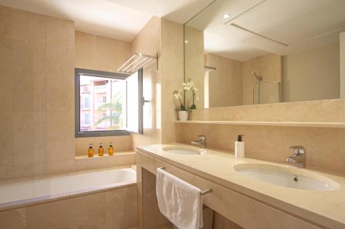 a bathroom with two sinks and a large mirror at Sotogrande Alboaire- Waterfront luxury 4 bedroom Apt in the Marina of Sotogrande in Sotogrande