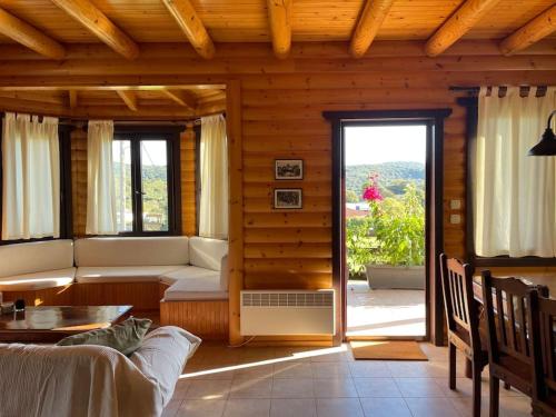 a living room with a couch and a table at Chalet Klimatia - Όμορφη ξύλινη μεζονέτα με τζάκι 