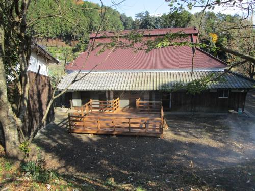 a barn with a group of horses in front of it at 一汁一菜の宿 ちゃぶダイニング Ichiju Issai no Yado Chabu Dining, A Private Farmstay in Rural Kyoto in Ayabe