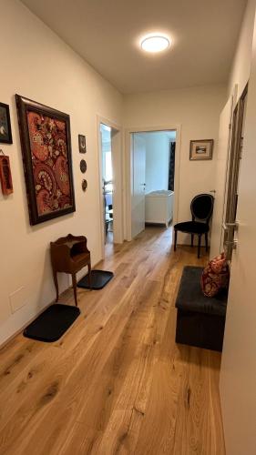 a living room with a wooden floor and a couch at Ferienwohnung Karasek Deluxe in Sattendorf