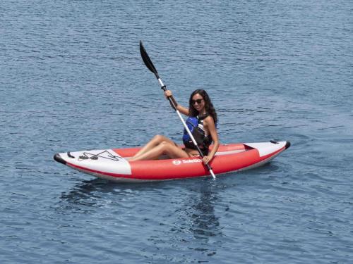 una mujer sentada en un kayak en el agua en Tentrr Signature Site - Hidden Forest, en Montgomery