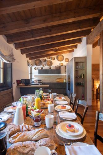 a long table with food on it in a kitchen at Kikombe Lodge in Sankt Anton am Arlberg