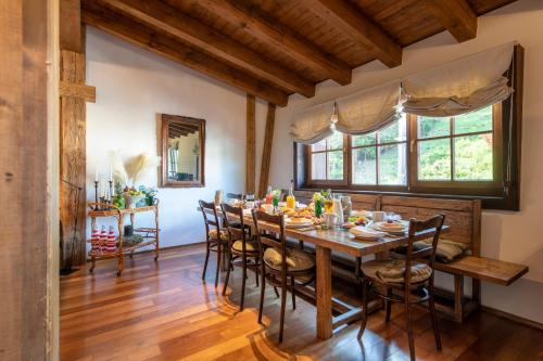 a dining room with a wooden table and chairs at Kikombe Lodge in Sankt Anton am Arlberg