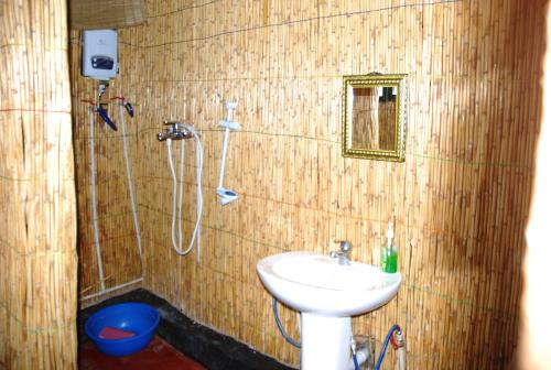 a bathroom with a sink and a shower at NYUNGWE VILLAGE in Kitabi