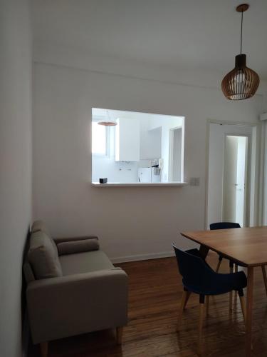 a living room with a couch and a table at Caminito Apart in Buenos Aires