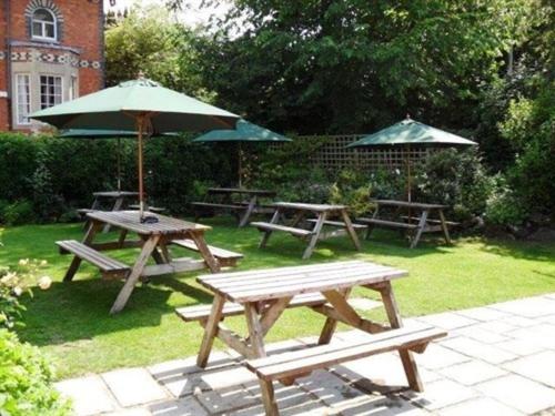 a group of picnic tables and an umbrella at White Horse Inn in Woolstone