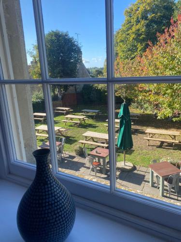 a window with a vase sitting on a window sill at The Castle Inn Bradford on Avon in Bradford on Avon